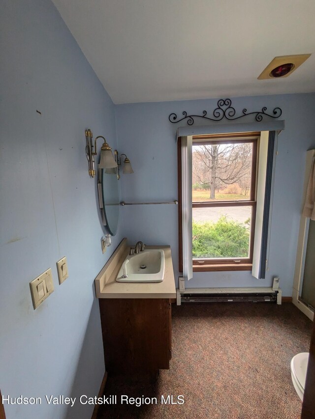 bathroom with vanity and a baseboard radiator