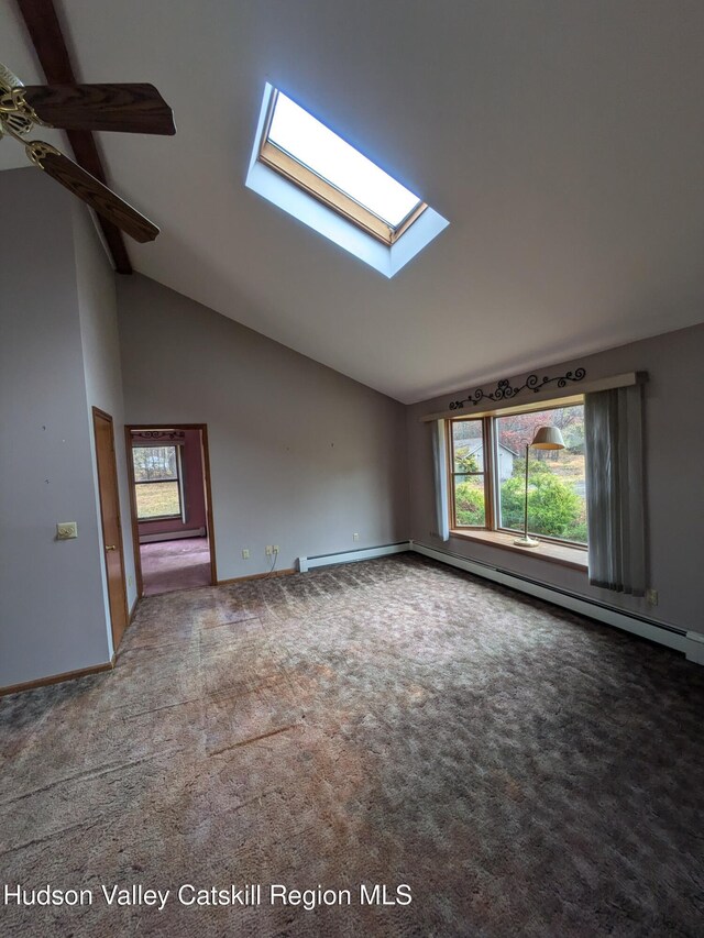 additional living space featuring carpet flooring, a skylight, and high vaulted ceiling