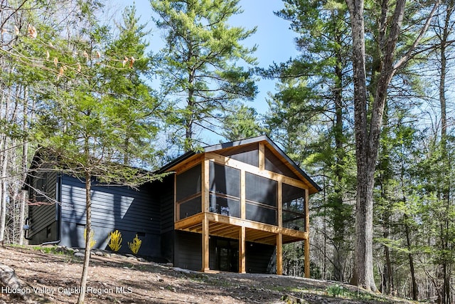 back of property featuring a sunroom