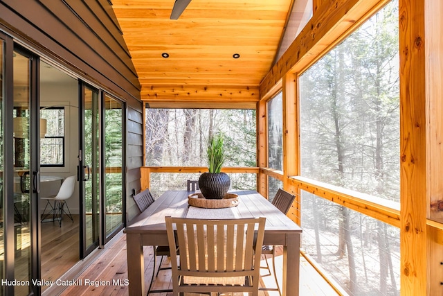 sunroom / solarium with wood ceiling, wood-type flooring, and lofted ceiling