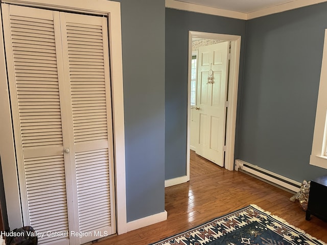 89 Bloomingdale Rd, Tillson, NY 12486 - hallway with baseboard heating, wood finished floors, and baseboards