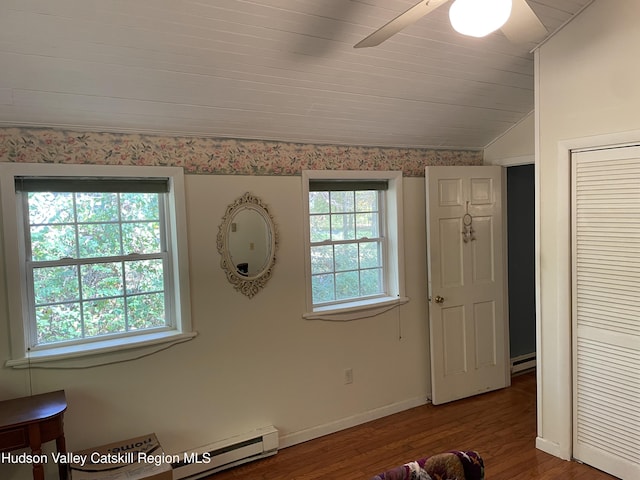 89 Bloomingdale Rd, Tillson, NY 12486 - unfurnished bedroom featuring a baseboard radiator, wood finished floors, lofted ceiling, baseboards, and ceiling fan