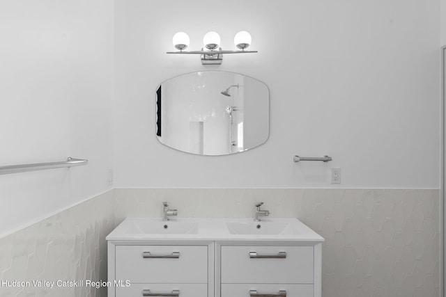 bathroom featuring vanity and tile walls