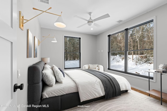 bedroom featuring multiple windows and ceiling fan