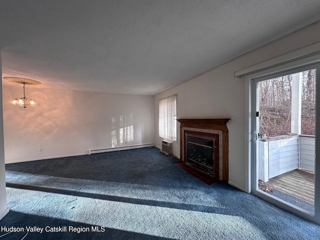 unfurnished living room with a textured ceiling, carpet, a baseboard heating unit, an inviting chandelier, and a wall mounted air conditioner