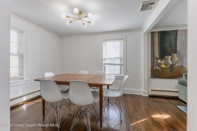 dining space featuring baseboard heating, ornamental molding, wood finished floors, and visible vents