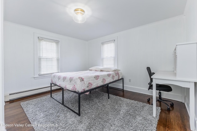 bedroom featuring wood finished floors, a baseboard radiator, and crown molding