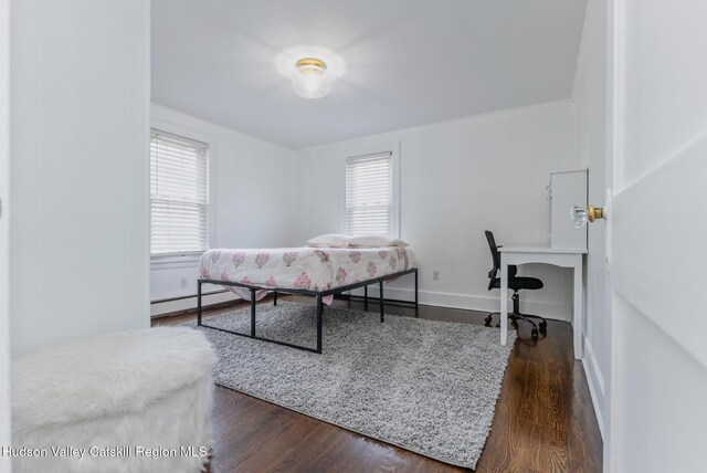 bedroom featuring dark wood-type flooring and a baseboard radiator