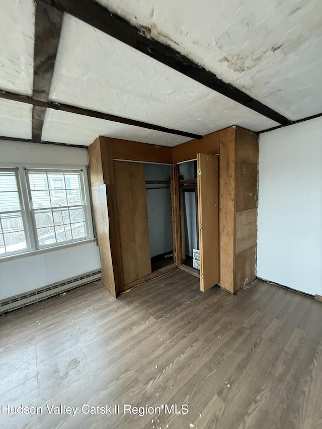 11 N Montgomery St, Athens, NY 12015 - unfurnished bedroom with light wood finished floors and a baseboard heating unit