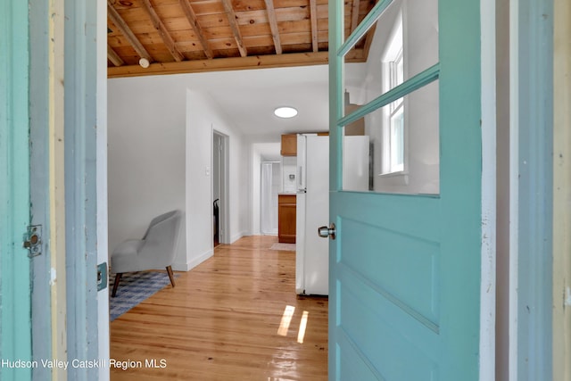entrance foyer featuring wooden ceiling, baseboards, and light wood-style flooring