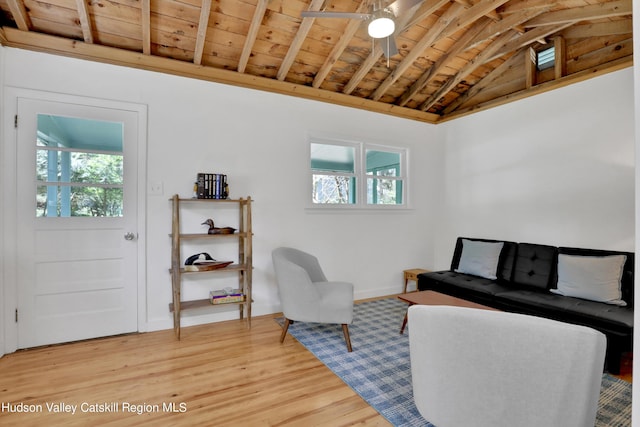 living area featuring a ceiling fan, a healthy amount of sunlight, wood ceiling, and light wood finished floors