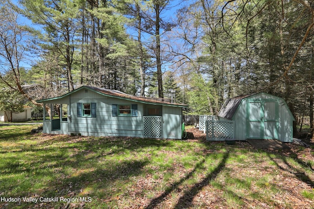 exterior space with a yard, an outdoor structure, and a shed