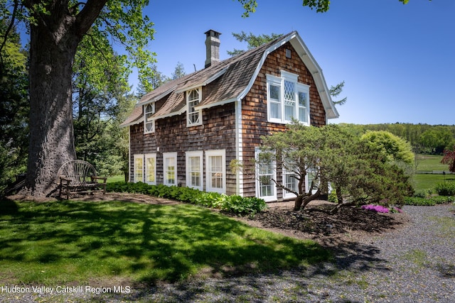 view of side of home with a yard