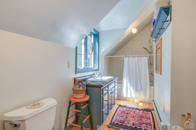 192 Old Queechy Rd, Canaan, NY 12029 - bathroom with baseboard heating, vaulted ceiling, toilet, wood finished floors, and shower / bath combo