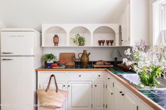 72 Old Queechy Rd, Canaan, NY 12029 - kitchen featuring freestanding refrigerator, open shelves, white cabinets, and tile countertops