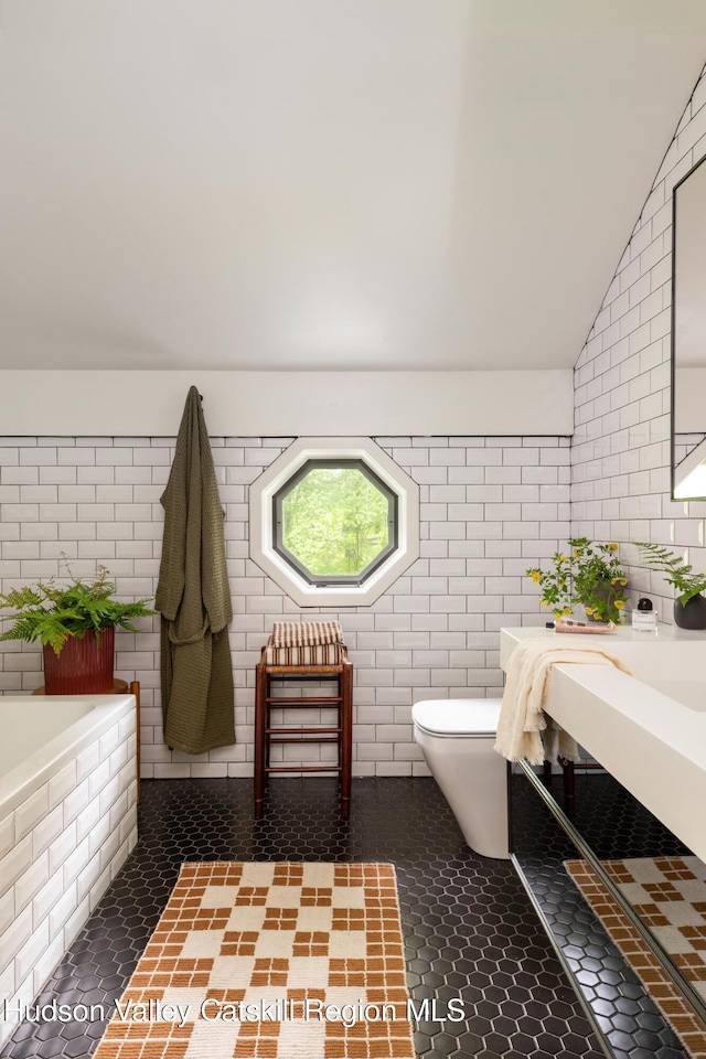 72 Old Queechy Rd, Canaan, NY 12029 - full bathroom with vaulted ceiling, tiled tub, and tile patterned floors