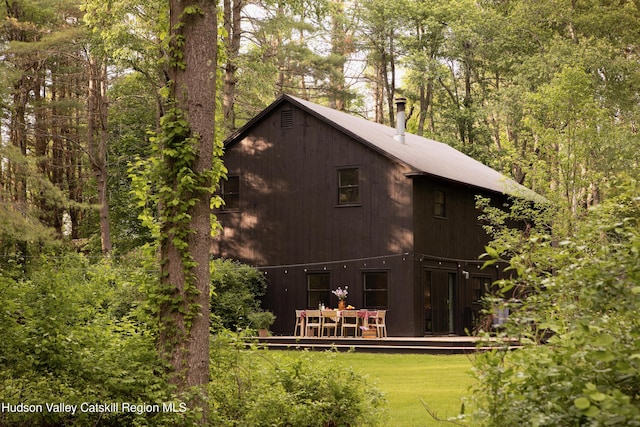 72 Old Queechy Rd, Canaan, NY 12029 - rear view of property featuring a deck, a lawn, and a forest view