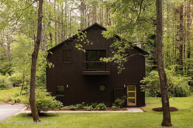 72 Old Queechy Rd, Canaan, NY 12029 - rustic home with a balcony, a front yard, and a forest view