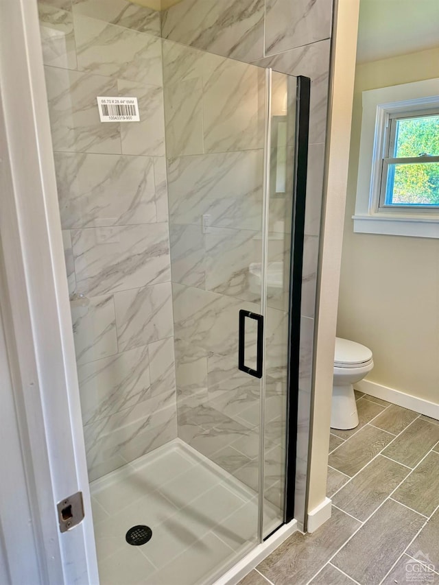369 Newry Ln, Greenville, NY 12083 - bathroom featuring a shower stall, toilet, and baseboards