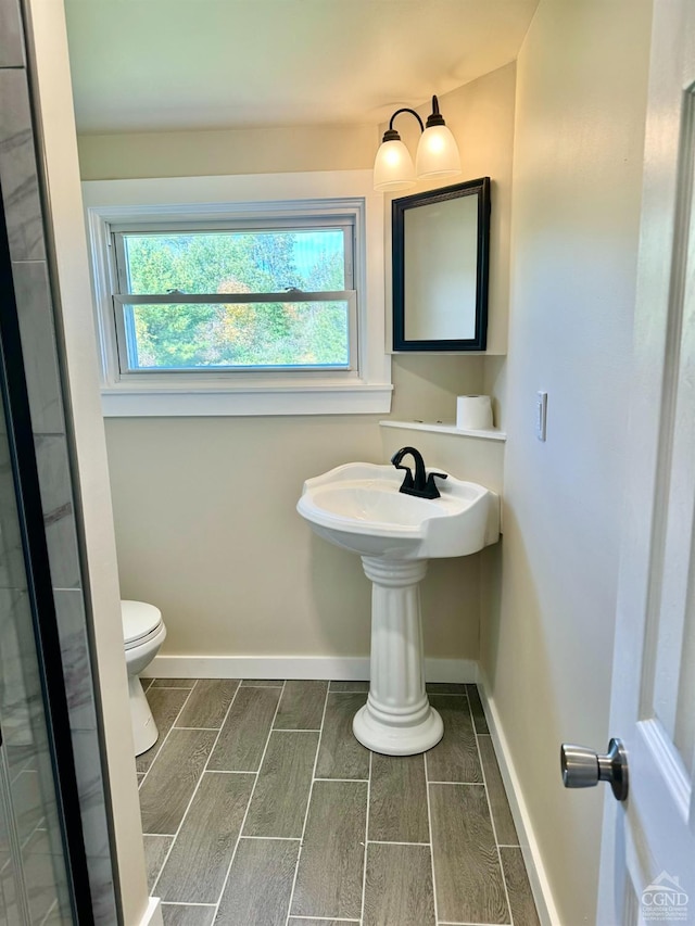 369 Newry Ln, Greenville, NY 12083 - bathroom featuring wood tiled floors, toilet, and baseboards