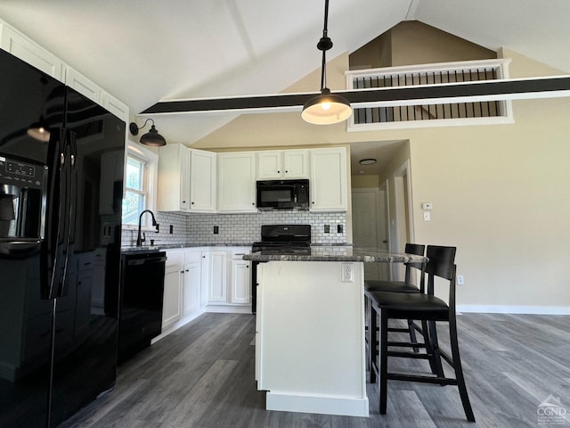 369 Newry Ln, Greenville, NY 12083 - kitchen featuring black appliances, white cabinetry, a kitchen island, vaulted ceiling, and dark wood finished floors