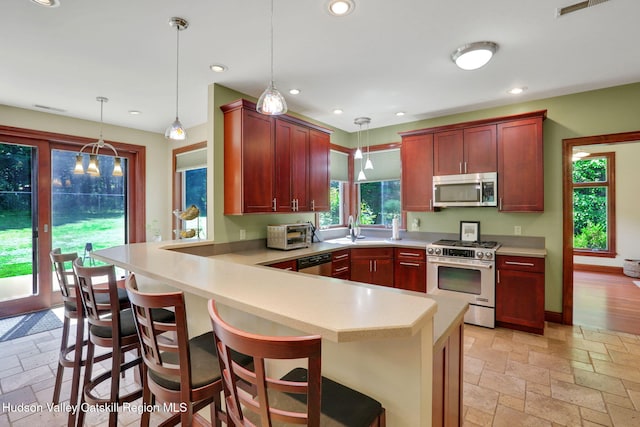 374 Linderman Ave, Kingston, NY 12401 - kitchen with appliances with stainless steel finishes, stone tile floors, a peninsula, light countertops, and recessed lighting