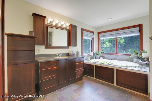 374 Linderman Ave, Kingston, NY 12401 - bathroom featuring vanity, a garden tub, stone tile flooring, and recessed lighting