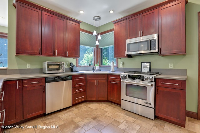 374 Linderman Ave, Kingston, NY 12401 - kitchen featuring stainless steel appliances, stone tile floors, recessed lighting, hanging light fixtures, and light countertops