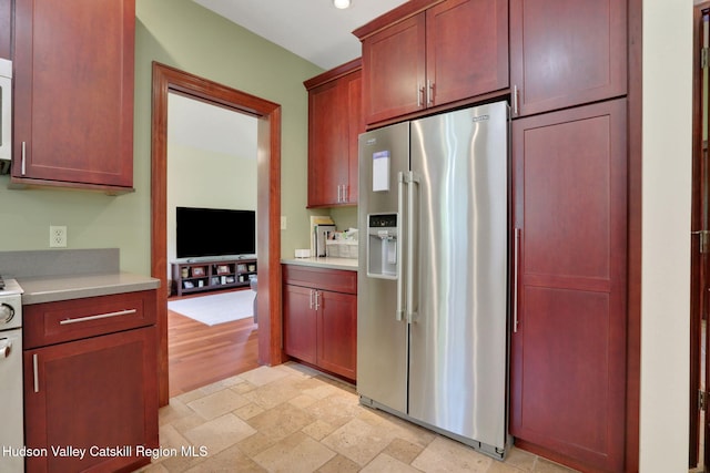 374 Linderman Ave, Kingston, NY 12401 - kitchen featuring high end refrigerator, light countertops, reddish brown cabinets, white microwave, and recessed lighting