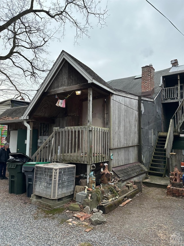 398 Main St, Catskill, NY 12414 - view of front of home featuring stairs, a chimney, and central AC