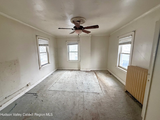 empty room with ceiling fan, radiator, and ornamental molding