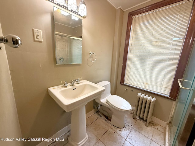 full bath with toilet, a stall shower, radiator, crown molding, and baseboards