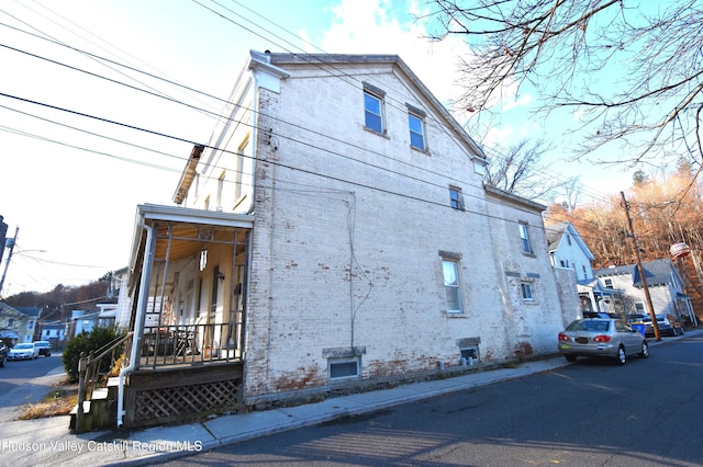 view of side of property with brick siding