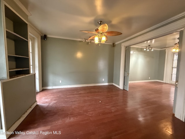 unfurnished room featuring baseboards, a ceiling fan, wood finished floors, and crown molding