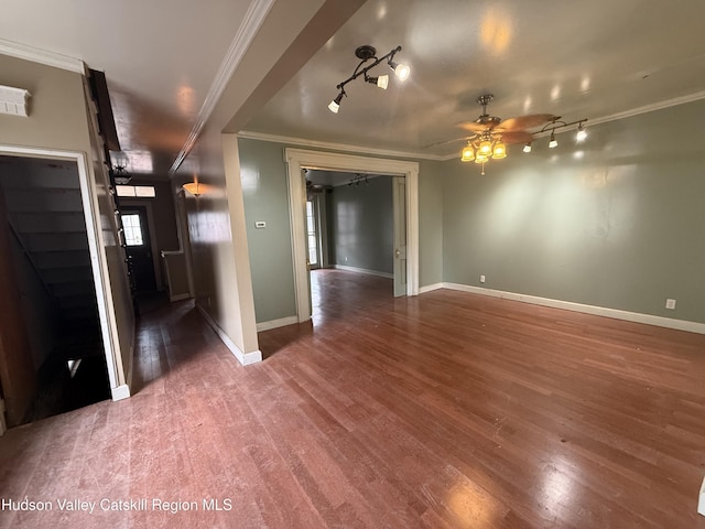 unfurnished room with ceiling fan, wood finished floors, baseboards, and ornamental molding