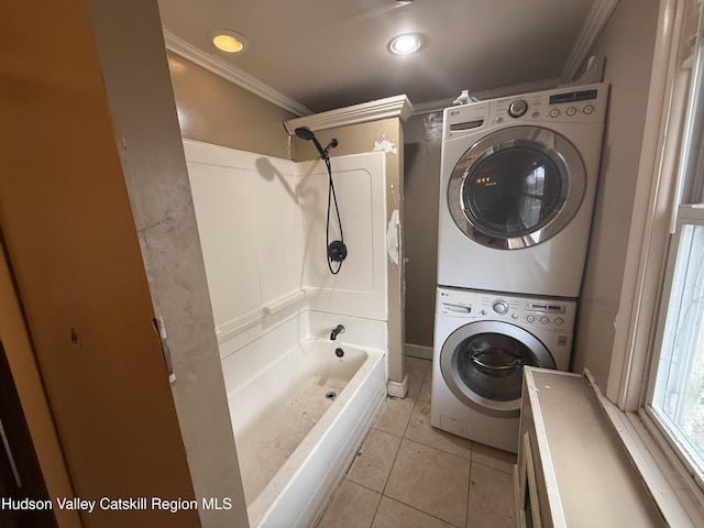 clothes washing area with laundry area, stacked washer and dryer, light tile patterned floors, and crown molding