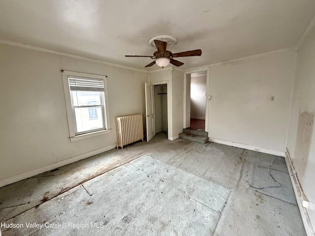 unfurnished bedroom with a closet, radiator heating unit, and a ceiling fan