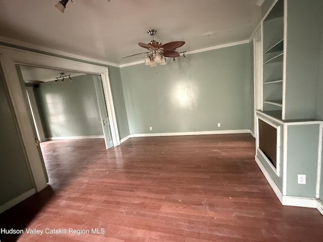 unfurnished room with ceiling fan, wood finished floors, and crown molding