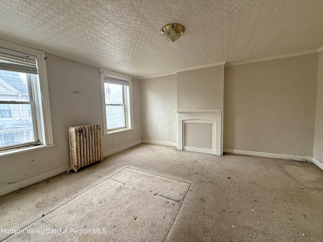 unfurnished living room featuring a wealth of natural light, radiator heating unit, baseboards, and ornamental molding