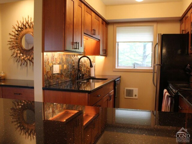 108 Brainard Ridge Rd Unit 14B, Windham, NY 12496 - kitchen with a sink, brown cabinetry, decorative backsplash, dark stone countertops, and black appliances