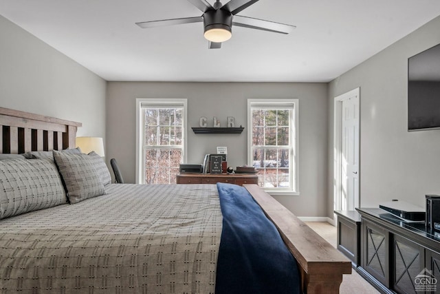 bedroom with carpet floors, ceiling fan, and baseboards