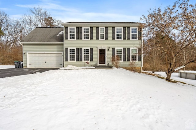 colonial home featuring an attached garage and driveway