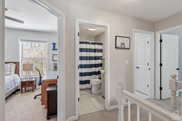 bathroom featuring ceiling fan, ensuite bathroom, and toilet