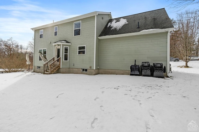 snow covered back of property with entry steps