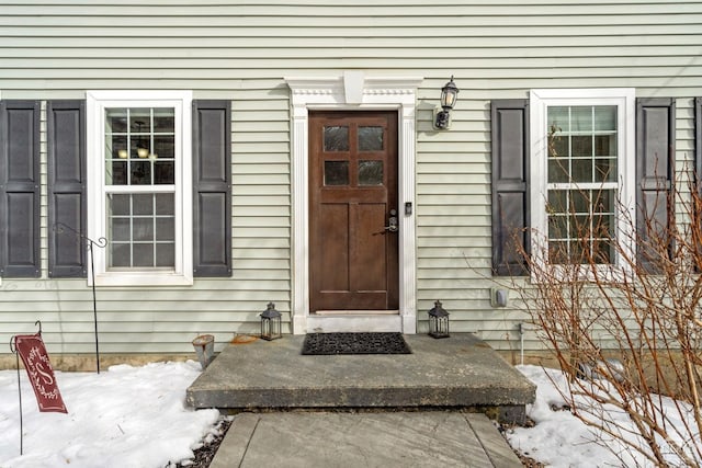 view of snow covered property entrance