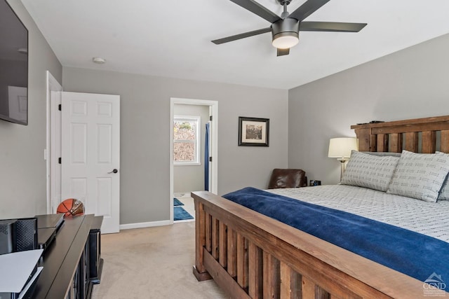 bedroom featuring light carpet, baseboards, and ceiling fan