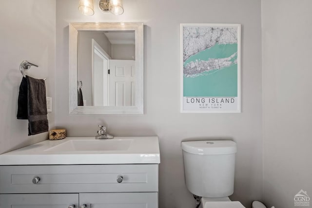 half bathroom with vanity and toilet