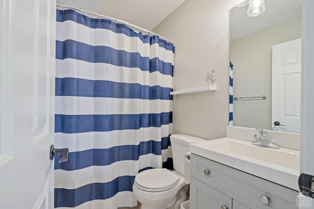 bathroom featuring toilet, vanity, and a shower with shower curtain