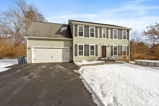 colonial house with driveway and an attached garage