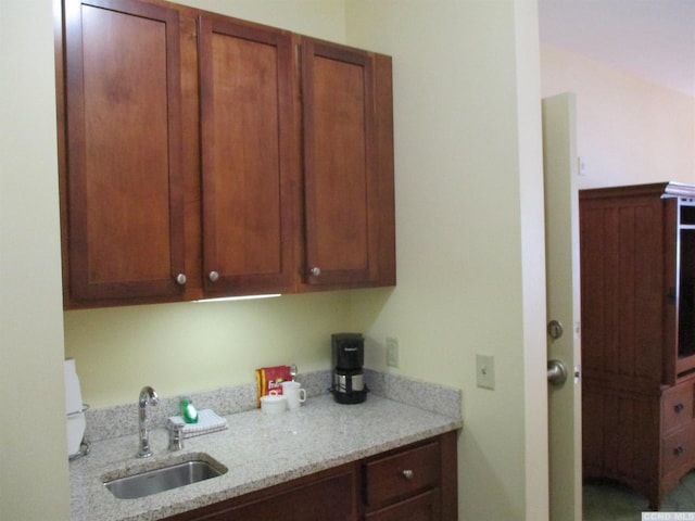 62 Liftside Dr Unit 306F1, Hunter, NY 12442 - kitchen with a sink, light stone counters, and brown cabinetry